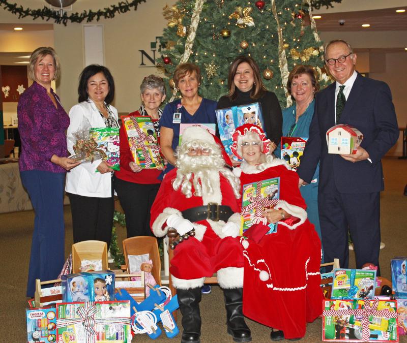 Pictured L-R: Front Row: Frank Johnston (Santa), and Linda Johnston (Mrs. Santa). Back Row: Lori Lee, RN, BSN, Assistant VP of Nursing; Rachel Gardner, Director of CDU/MSU; Vicki Strohmaier, RN; Dawn Ryan, RN; Penny Short, RN, BSN, COO & CNO; Lana Gillespie, RN, Director of Perioperative Services; and Steve Rose, RN, MN, NHS President/CEO